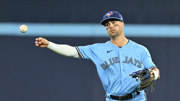 Aug 28, 2023; Toronto, Ontario, CAN; Toronto Blue Jays second baseman Whit Merrifield (15) throws out Washington Nationals first baseman Dominic Smith (not pictured) in the eighth inning at Rogers Centre. Mandatory Credit: Dan Hamilton-USA TODAY Sports